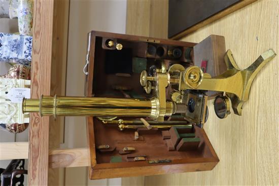 A Victorian brass scientific microscope by Ross, London, boxed with a case of slides